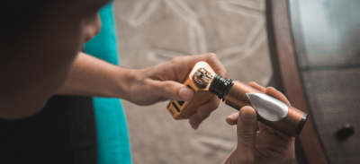 A person filling their e-cigarette with fluid.