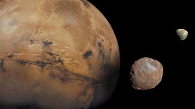 A picture of the planet Mars with two of its moons - Phobos and Deimos. 