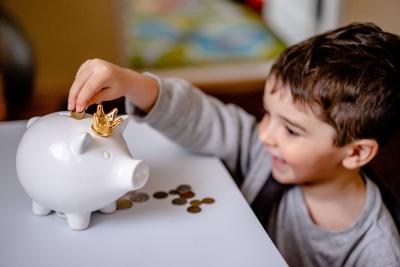 A child saving money in a piggy bank