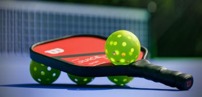 Red and black pickle ball paddle and green balls