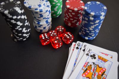 Close up of poker chips, red dice and playing cards. 