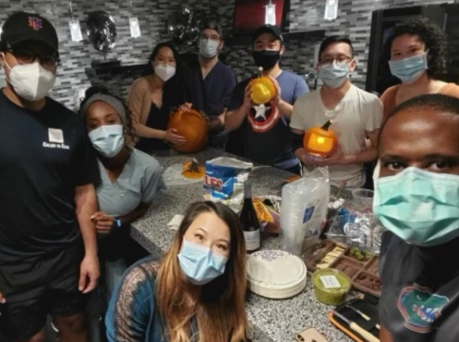 Anesthesia residents carve Halloween pumpkins at a department wellness event.