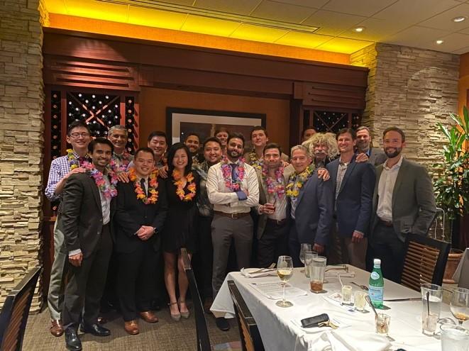 Recent R4 graduates at their residency graduation, wearing leis gifted by their coresident Brian Imada.