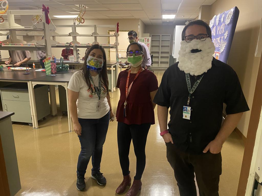 CTRID T32 trainees posing in decorated face masks during the Center’s annual holiday party.