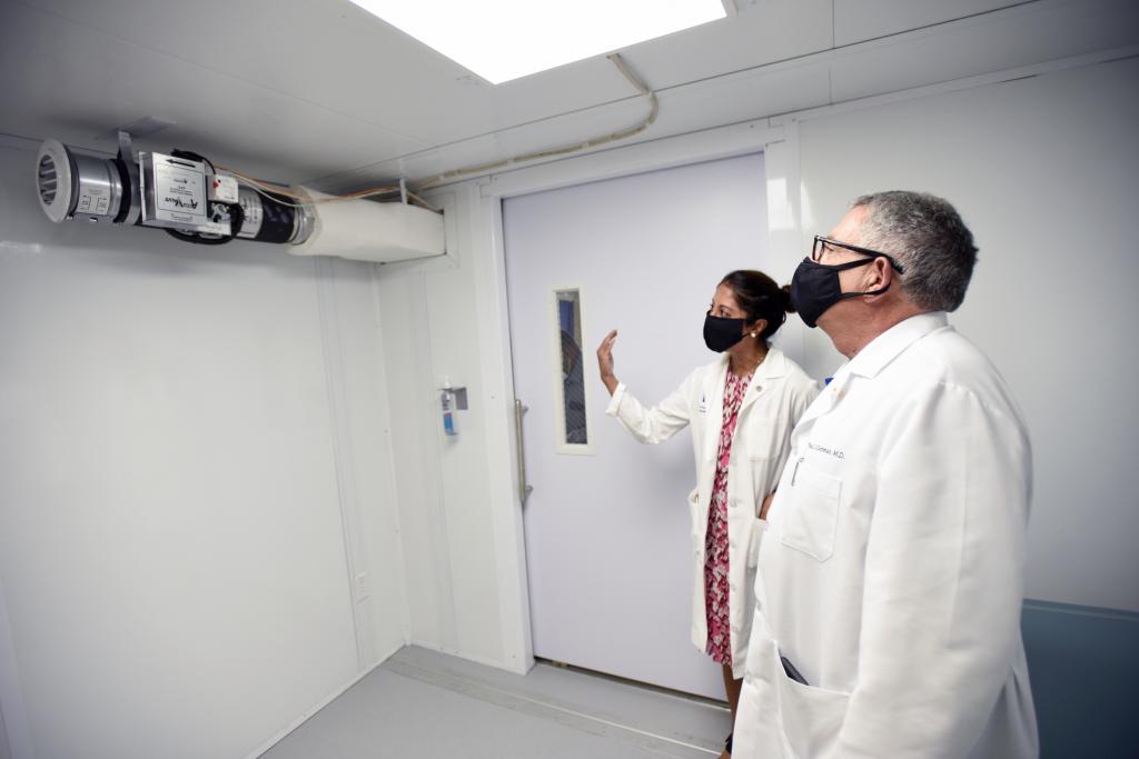 Two doctors touring a Smart Pod customized to act as a Negative Pressure Isolation room