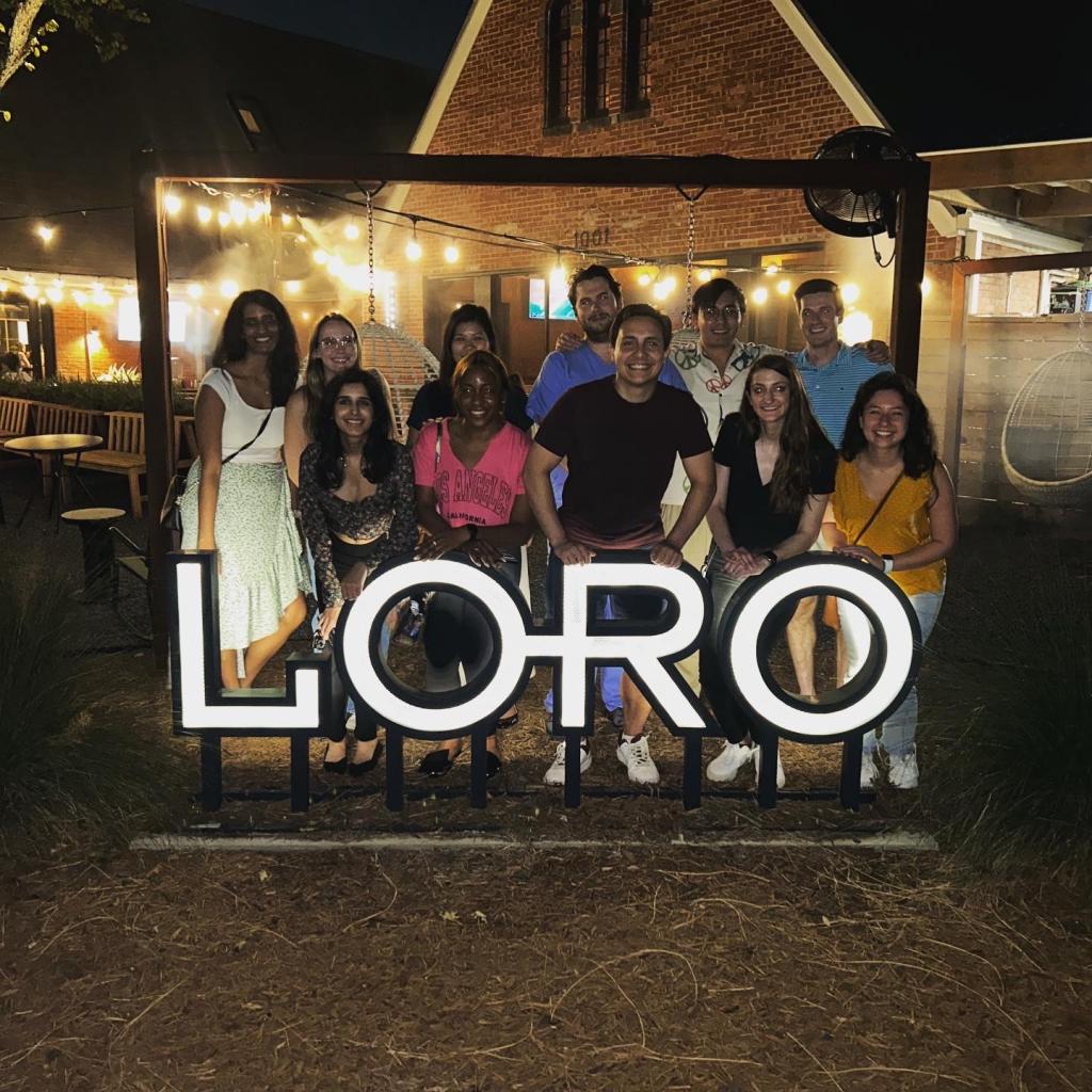 A group standing outside a restaurant called Loro