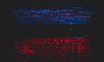 Image of a glowing computer screen and a glowing keyboard