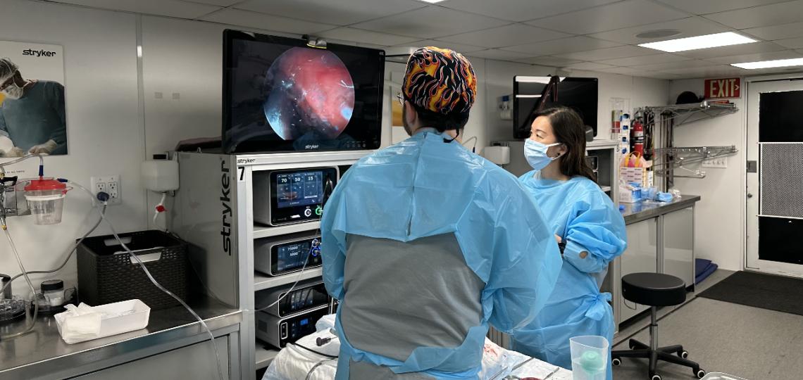 2 people performing an eye procedure