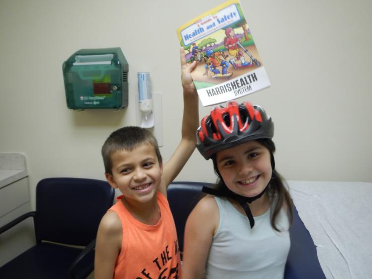 Physicians and residents gave away bicycle helmets, discusses safety during the summer months.
