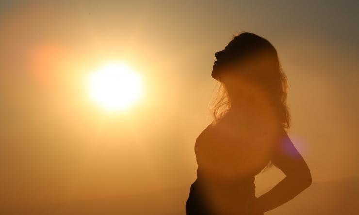 Silhouette of pregnant woman in sun