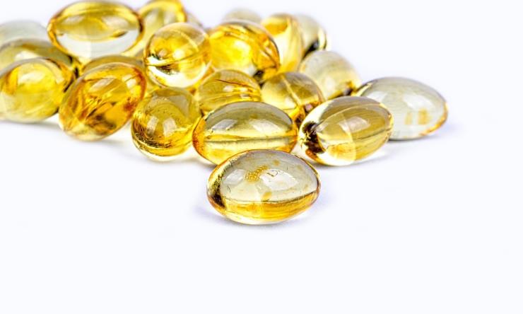 Photo of a pile of vitamin D pills on a white background