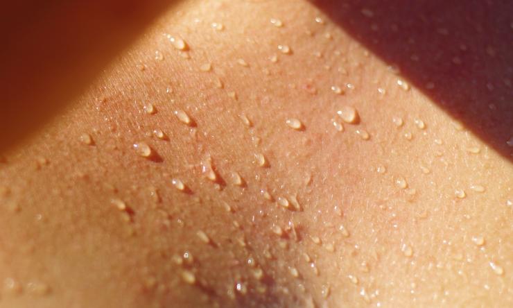 Close up photo of sweat on a person's chest.