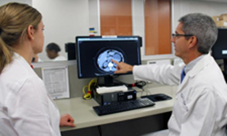William Fisher, M.D., consults with a general surgery resident.