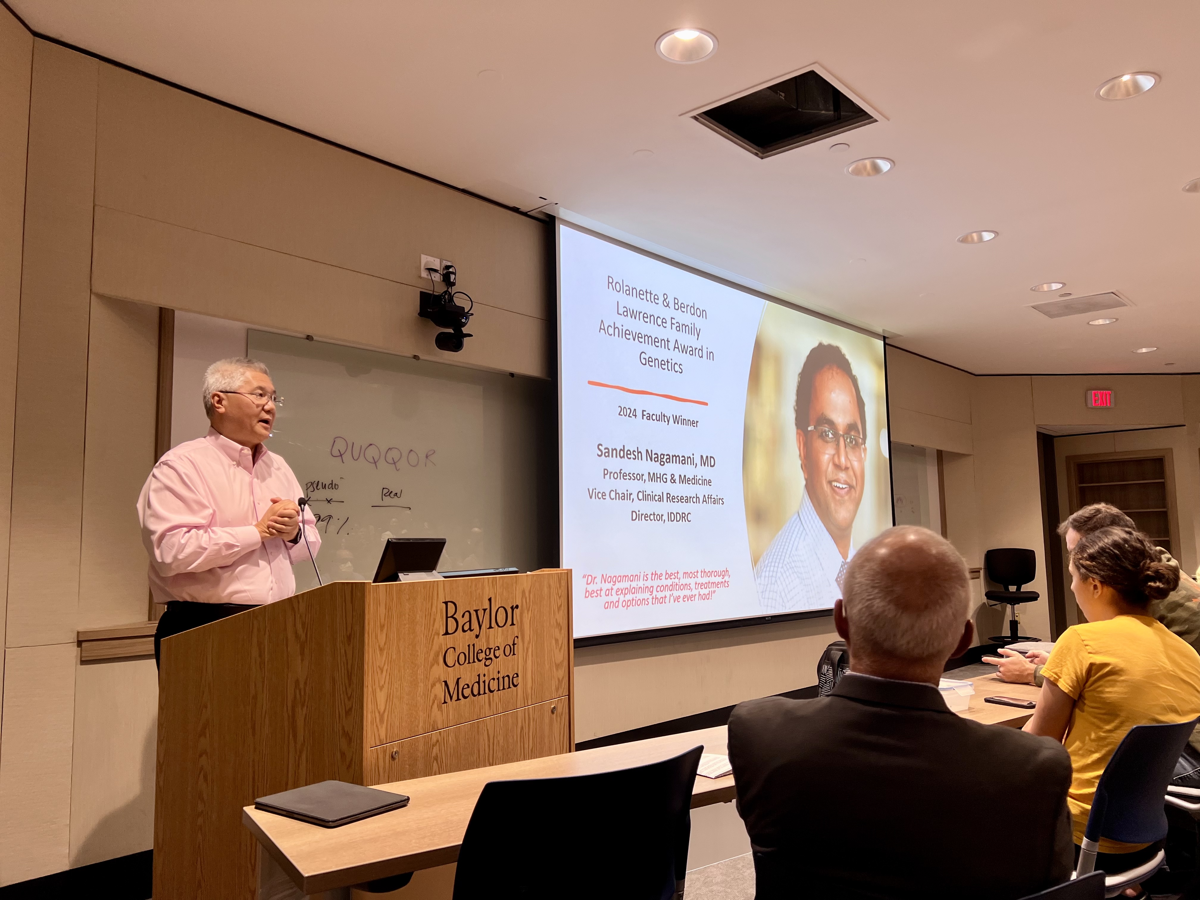 Dr. Lee announcing Rolanette and Berdon Lawrence Family Achievement In Genetics 2024 Awards Recipient Dr. Sandesh Nagamani