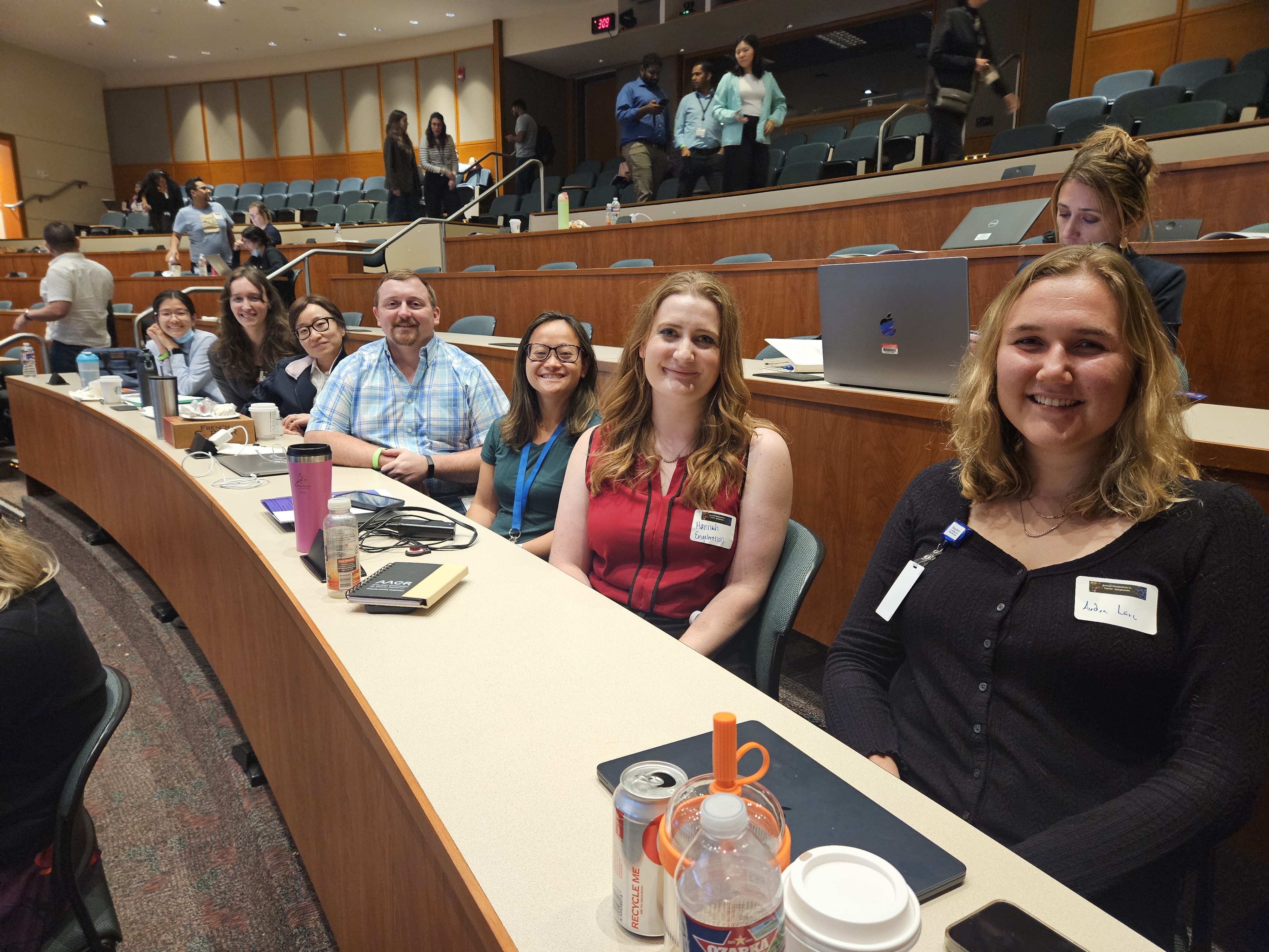  group of people sitting in auditorium