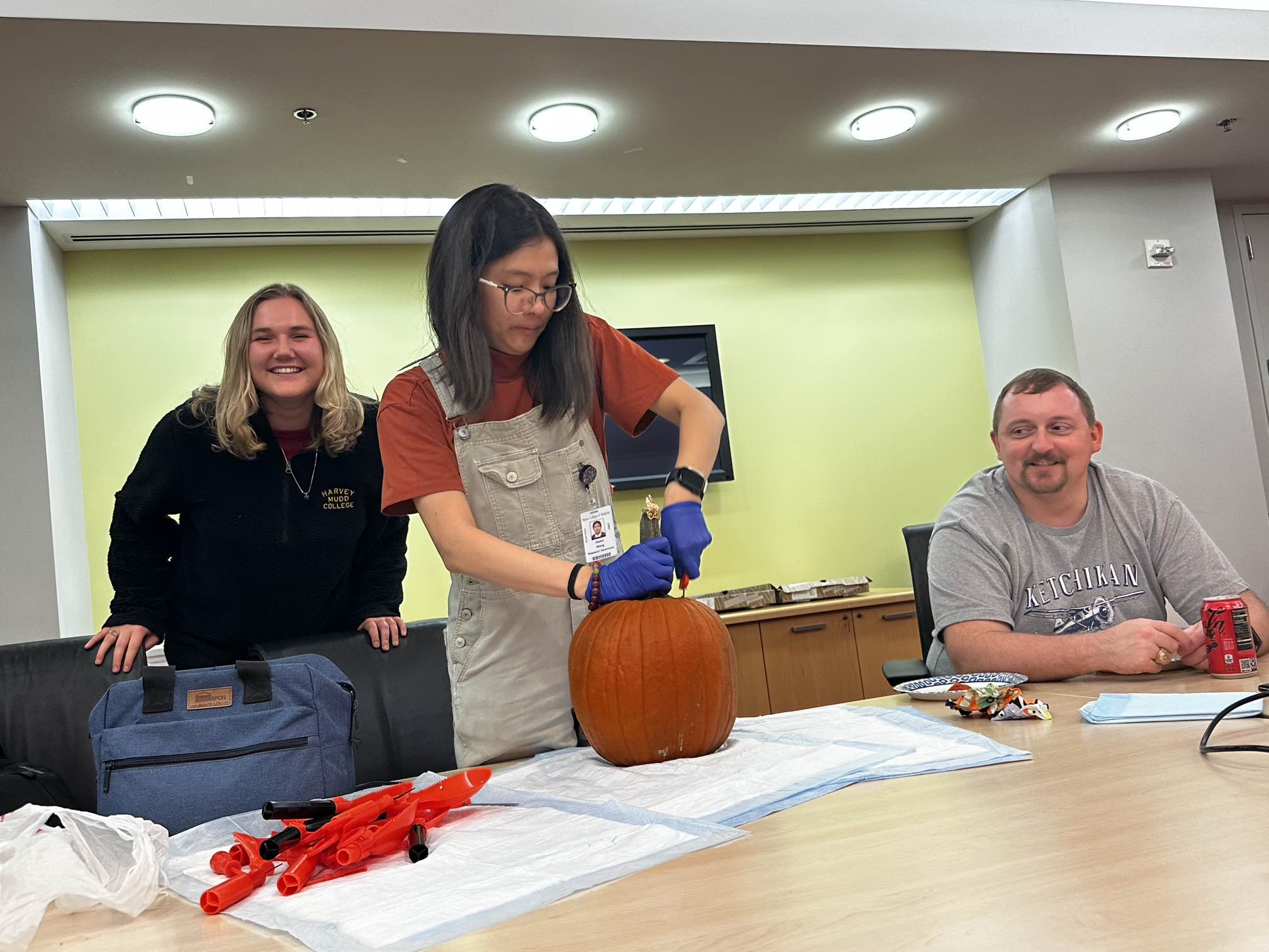 woman carving a pumpkin