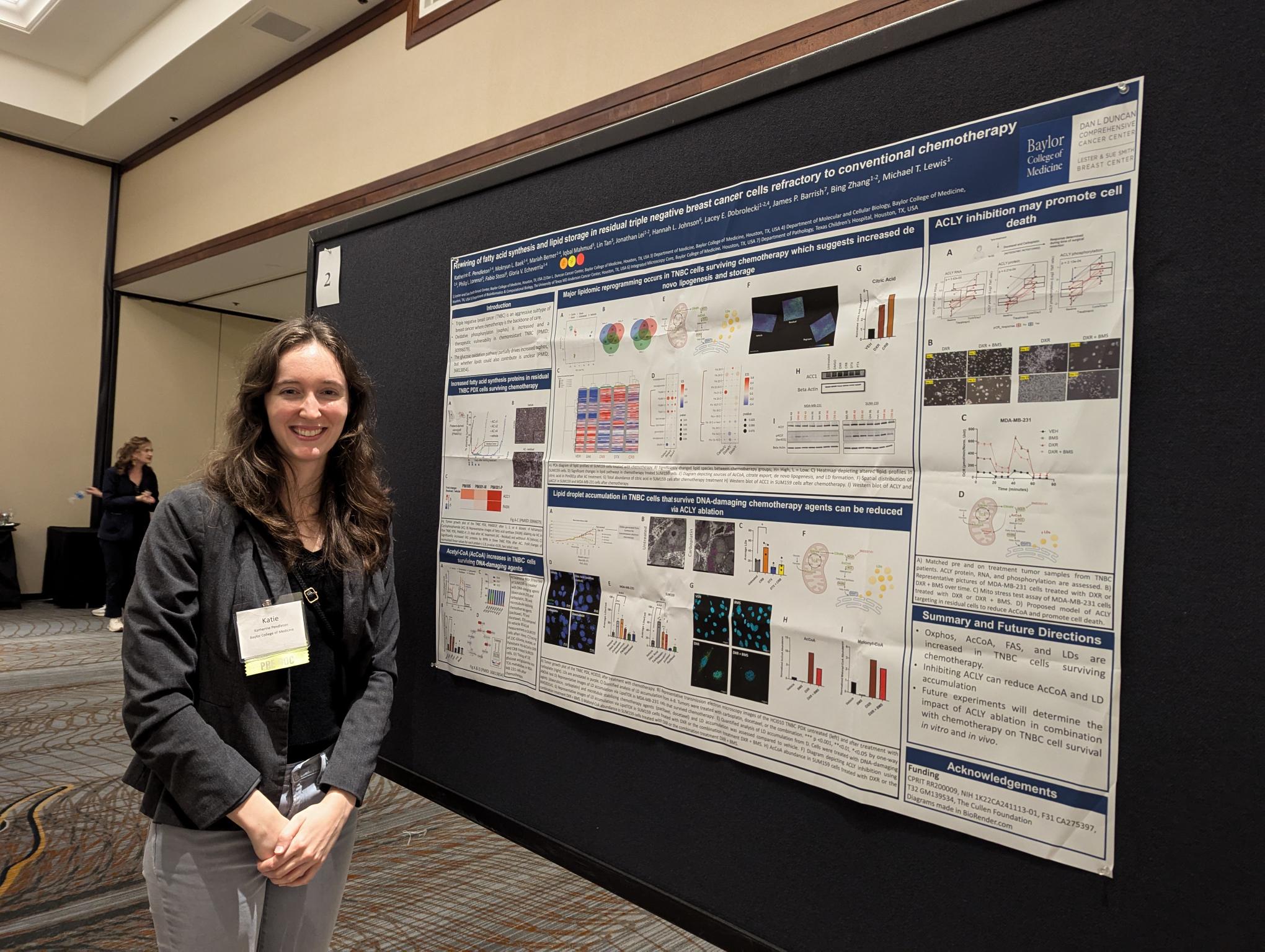 woman standing in front of poster