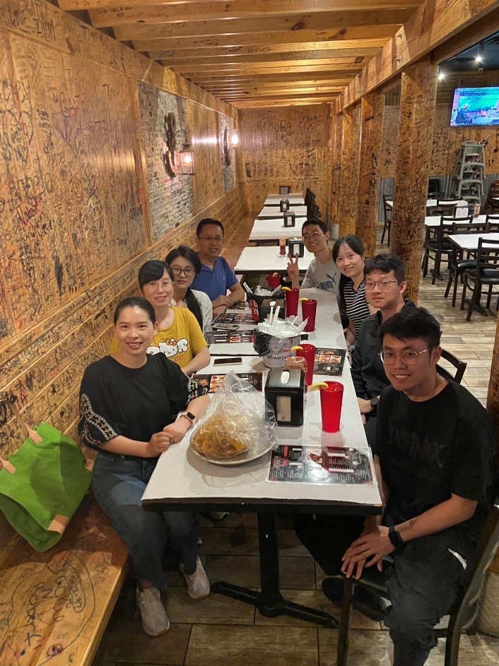 group of people sitting around a dinner table