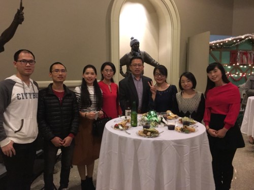 group of people sitting around a dinner table