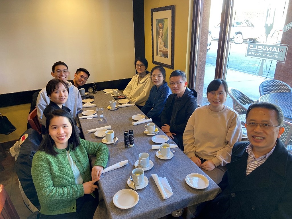 group of people sitting around a dinner table