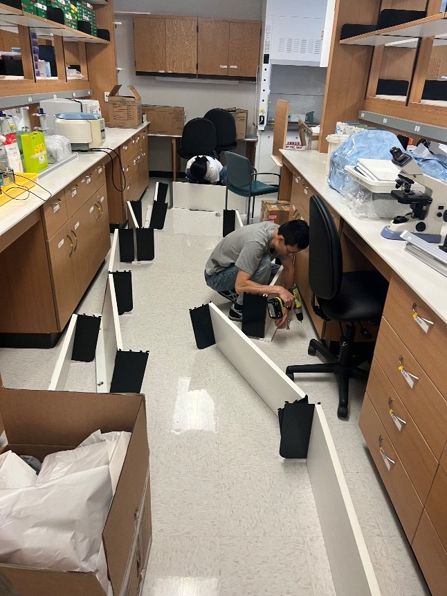 person working on the floor of a lab