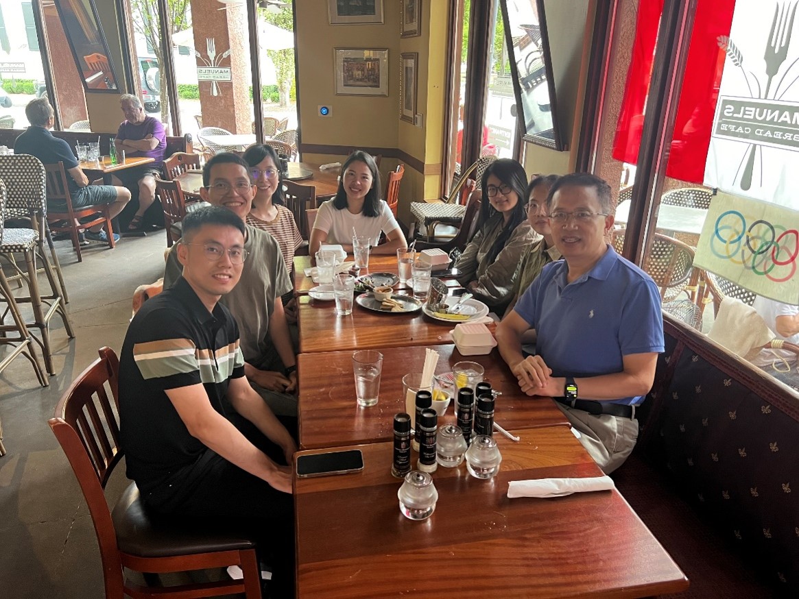 group of people sitting around a restaurant table