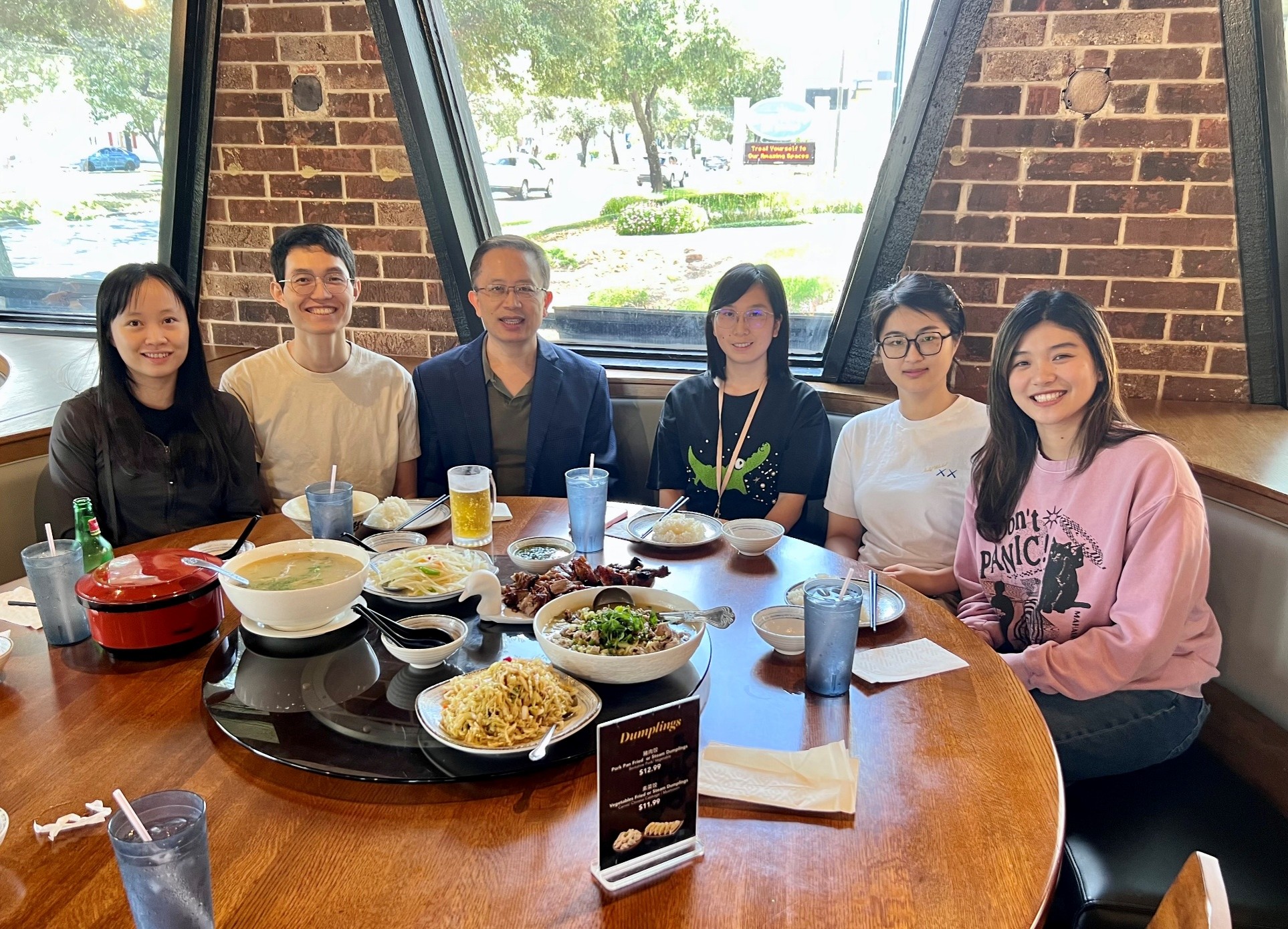 a group of people sitting at a table in a restaurant. 