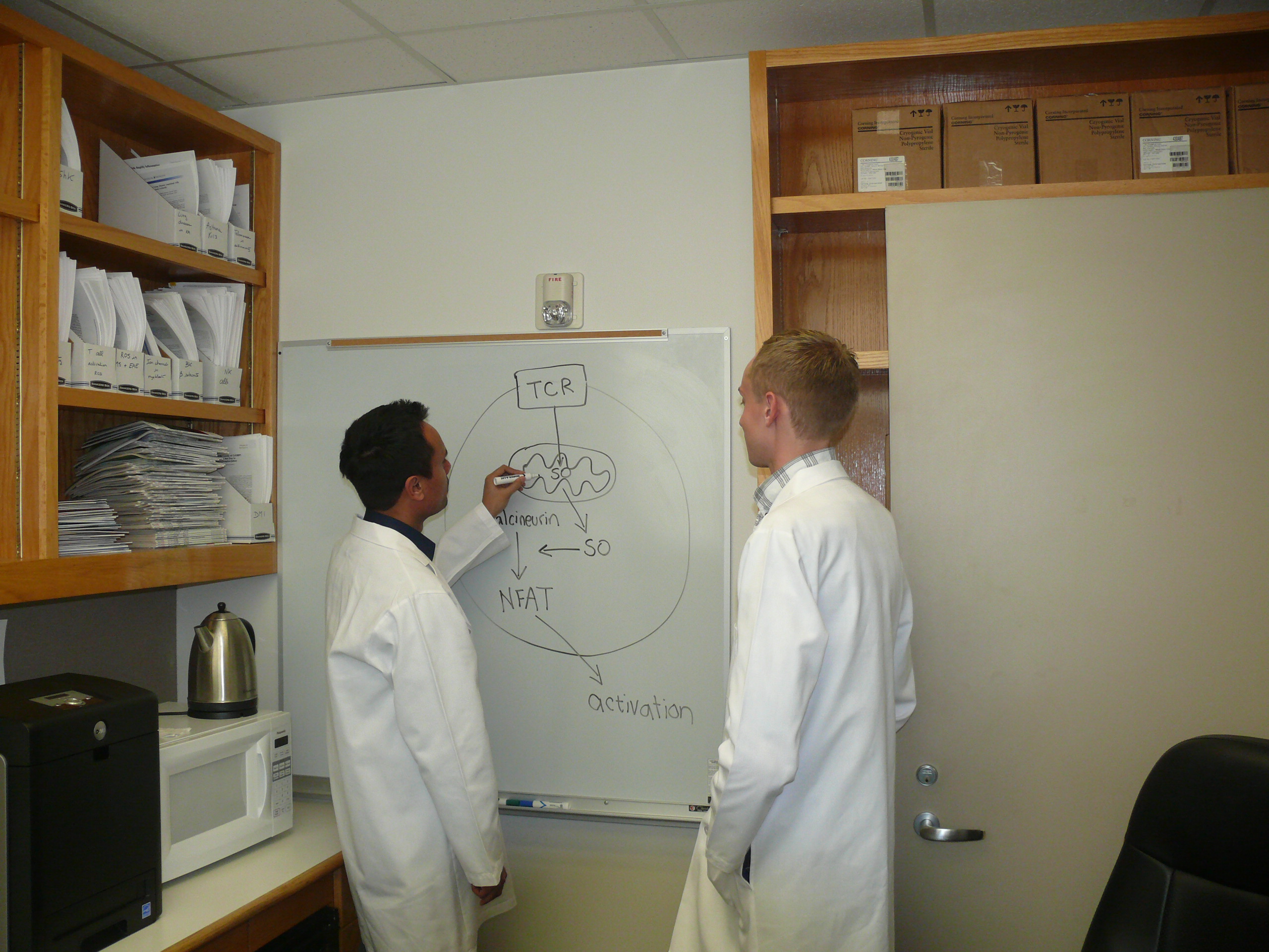 Redwan Huq explaining his hypothesis to Mark R. Tanner