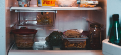 A refrigerator filled with leftover meals, vegetables and dairy products