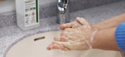 A person washing their hands with soap.