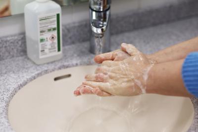 A person washing their hands with soap.