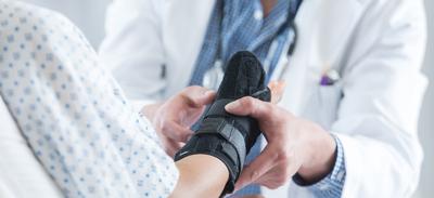 doctor with patient wearing soft cast