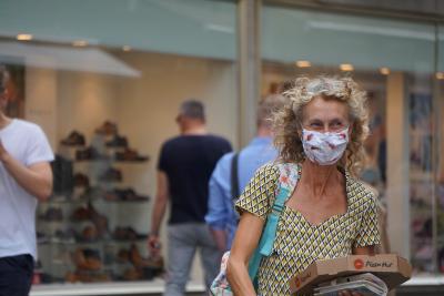 A person wearing a face mask in a mall.