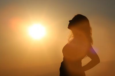 Silhouette of pregnant woman in sun