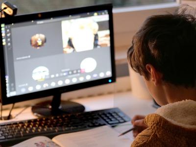 Child attending virtual school on computer