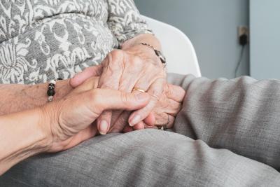 elderly family member holding hands