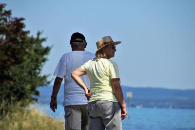 Older couple walking in the shade