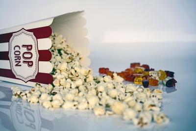 Photo of popcorn and gummie bears to represent movie snacks.