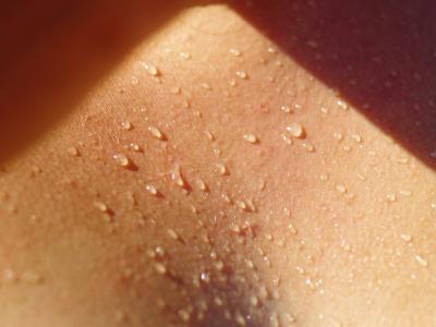 Close up photo of sweat on a person's chest.