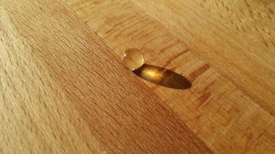Photo of a vitamin D pill on a wooden table top.