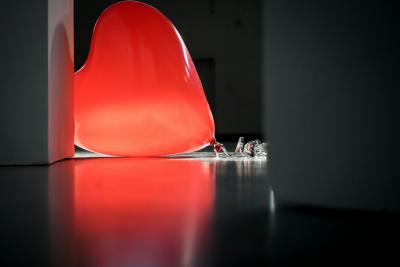 Photo of a heart shaped balloon on the ground to represent a sad or broken heart