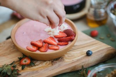 Photo of strawberry yogurt with chopped strawberries and other fruit.