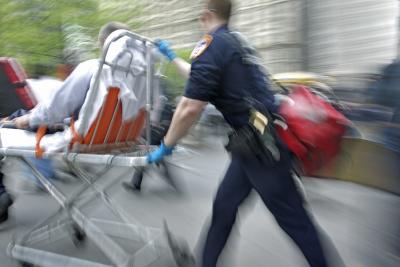 Emergency medical experts bring a trauma patient to a hospital.