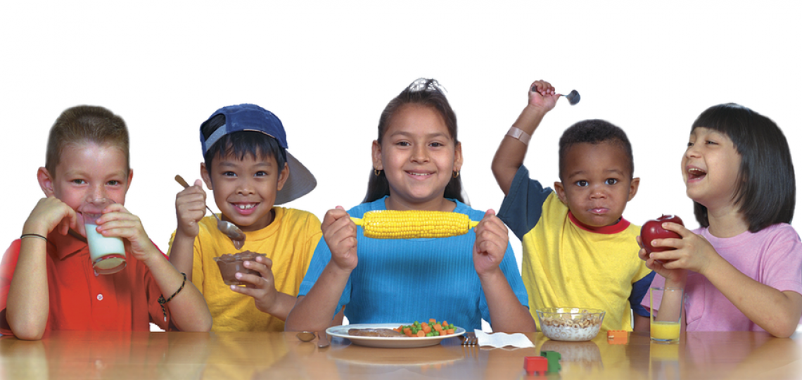 A group of children eating healthy food.