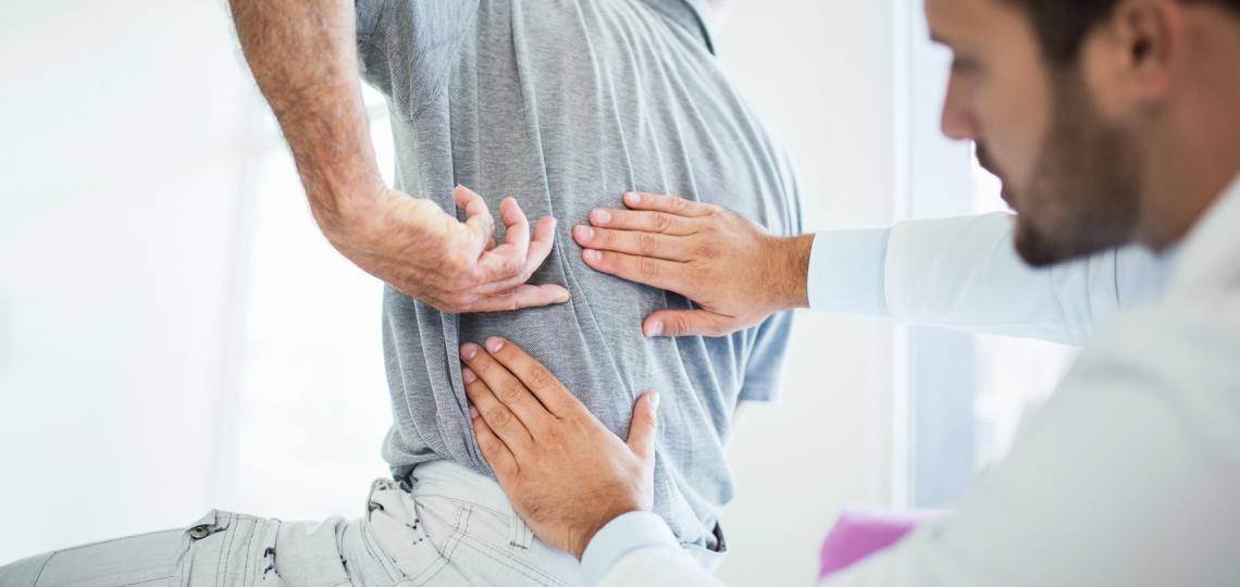 patient interacting with doctor to describe back pain
