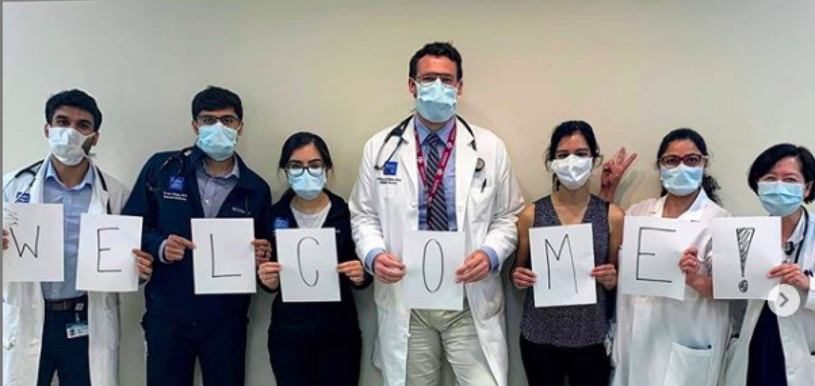 Internal Medicine residents holding a welcome sign