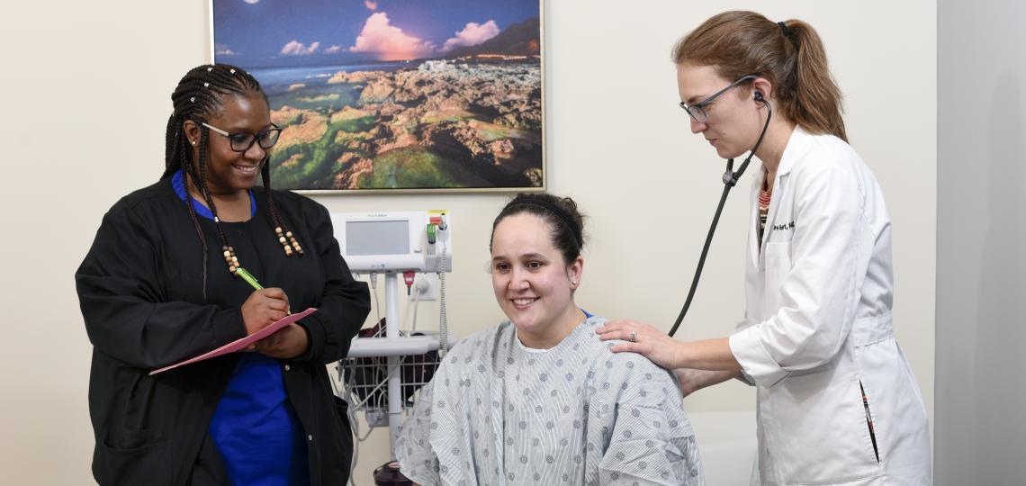 Physician and nurse with patient