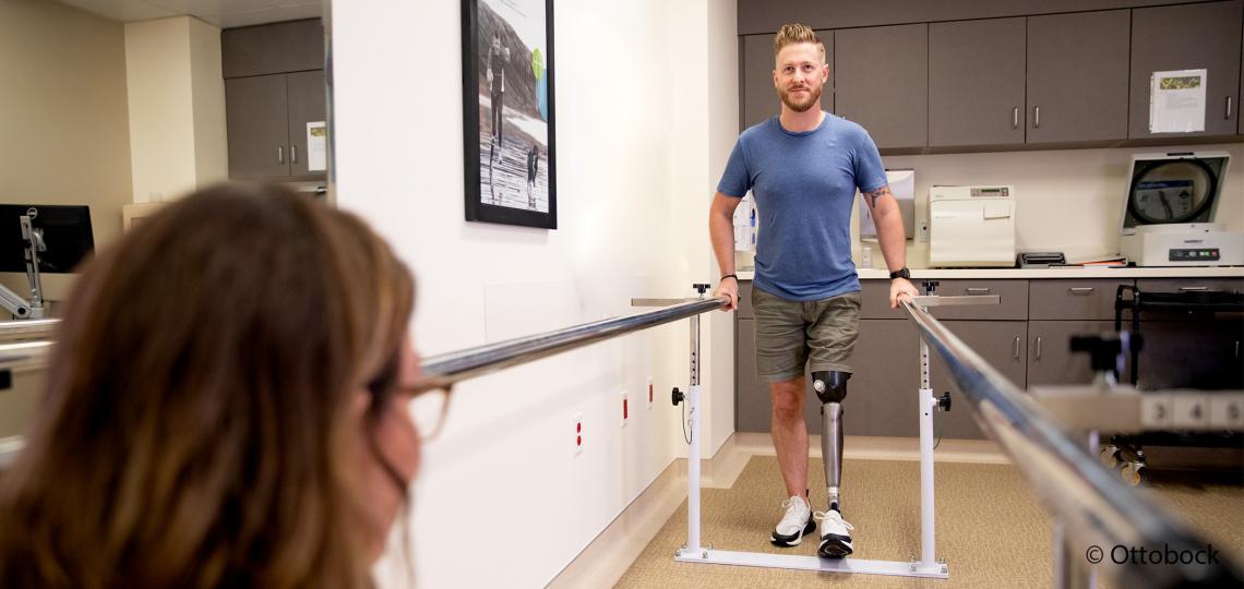 Man with prosthetic leg in physical therapy