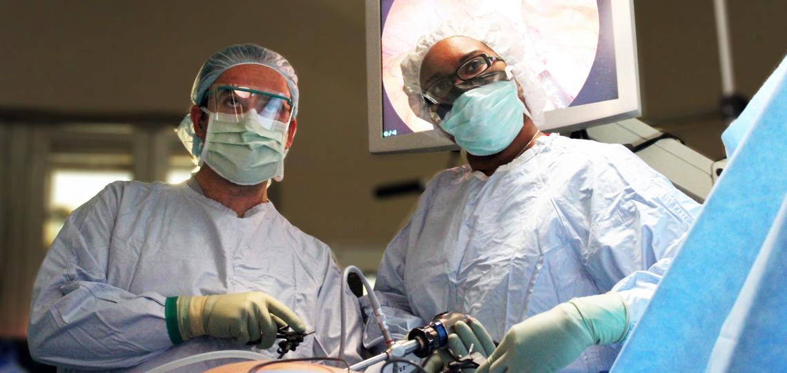 Two surgeons performing laparoscopic surgery in an operating room
