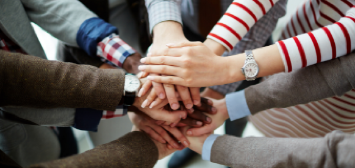 Group of hands stacked in the middle.